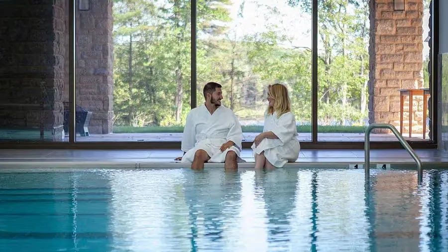 couple in bathrobes at indoor pool at YO1